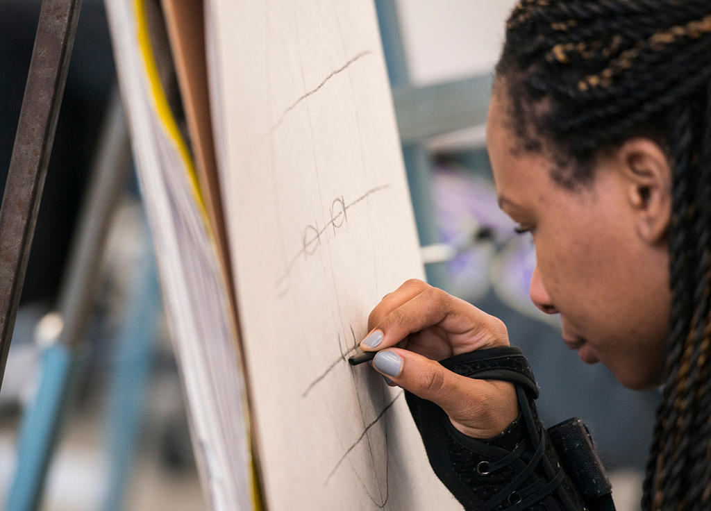 african american woman drawing on canvas