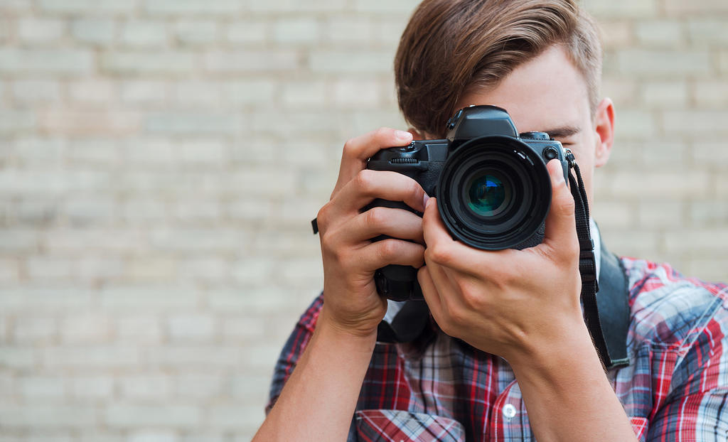 man taking photograph facing us