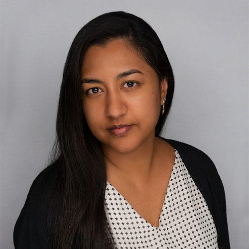Dr. Miriam Ahmed standing in front of white background