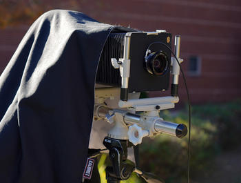 using traditional photography equipment with hood during an outdoor lesson